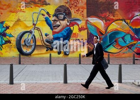 Man striding through downtown Bogota in headphones, Colombia. Stock Photo