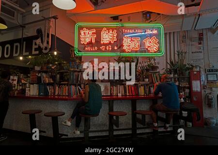 Customers having lunch at a noodle bar in the Chelsea Market, which sprawls over the block-long former National Biscuit Company building in Manhattan. Stock Photo