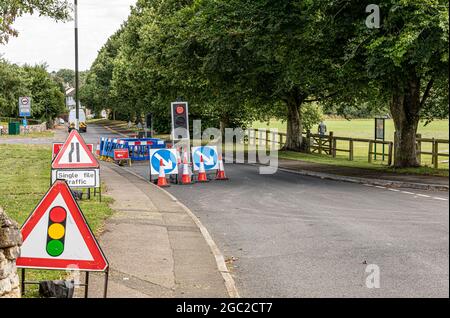 road works to  repairing a leaking water main in a rural village in the southwest of the UK Stock Photo