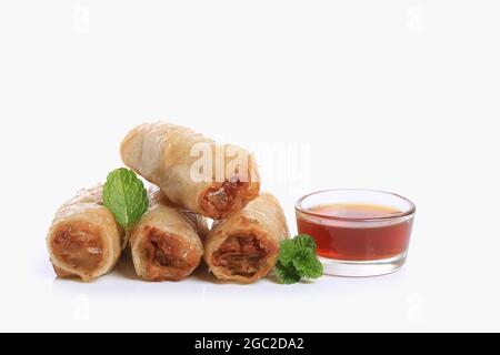 Spring rolls with nuoc mam sauce and mint leaves on a white background Stock Photo