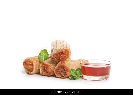 Spring rolls with nuoc mam sauce and mint leaves on a white background Stock Photo
