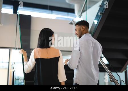 Diverse male and female business colleagues smiling and talking Stock Photo
