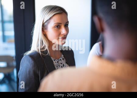 Diverse group of business colleagues discussing and having meeting Stock Photo
