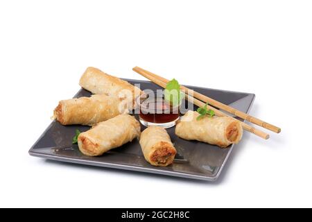 Spring rolls with nuoc mam sauce and mint leaves on a white background Stock Photo