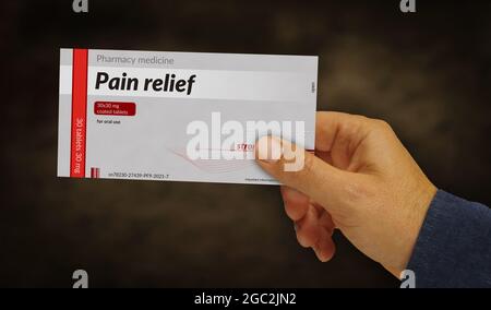 Pain relief tablets box in hand. Emergency painkiller, headache analgesic and help medical pills pack factory. Abstract concept 3d rendering illustrat Stock Photo