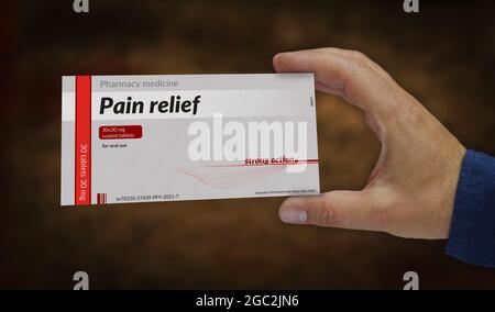 Pain relief tablets box in hand. Emergency painkiller, headache analgesic and help medical pills pack factory. Abstract concept 3d rendering illustrat Stock Photo