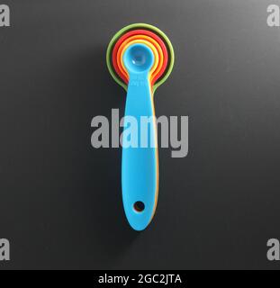 Colorful measuring spoons isolated on black Stock Photo