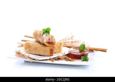 Spring rolls with nuoc mam sauce and mint leaves on a white background Stock Photo