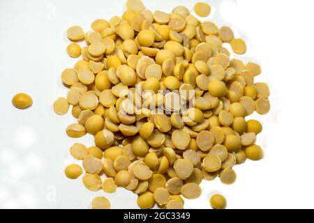 Pile dried split soy beans isolated on white background,Healthy food,diet food,raw seed Stock Photo