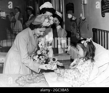 Princess Elizabeth being shown a doll by a 10 year girl patient during her visit to the Queen Elizabeth hospital for Children Hackney London 1948 Stock Photo