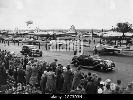 Queen Elizabeth II and Duke of Edinburgh driving in an open car past a line of Venom Jets Fighters of the 2nd A T A F at Odiham during Queen's Coronation Review July 1953 Stock Photo