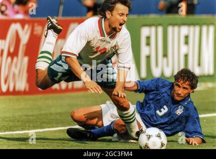 Antonio Benarrivo of Italy trips Bontcho Guentchev of Bulgaria during a 1994 FIFA World Cup match Stock Photo