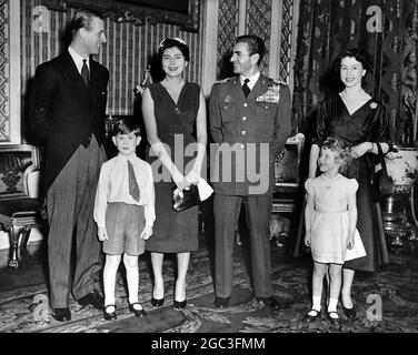 The Shah of Persia and his 21 year old wife Queen Soraya who are at present on a private visit to this country, were the luncheon guests of H M The Queen and HRH Duke of Edinburgh at Buckingham Palace 18th February 1955 Prince Philip , Queen Soraya of Persia , the Shah of Persia HM the Queen and the royal children Prince Charles and Princess Anne Photographed by Stuart Heydinger Stock Photo