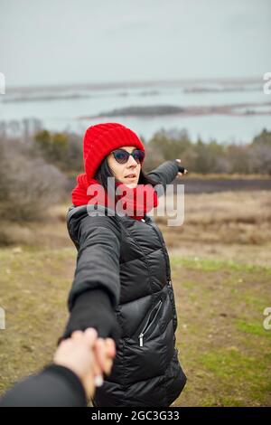 Couple travelers follow holding hands at foggy river landscape, Young family traveling active adventure vacations, woman and man love and travel happy Stock Photo