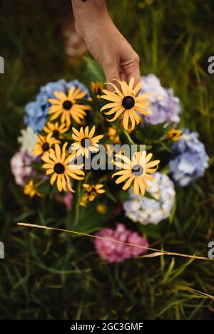 Caucasian girl holding basket of flowers Stock Photo - Alamy