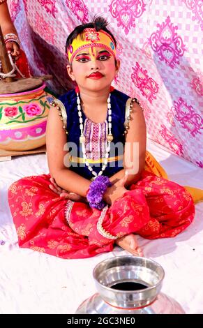 Hansi, haryana, August 2020 : A child rolling Lord Krishna with a pot of butter - Janmashtami concept Stock Photo