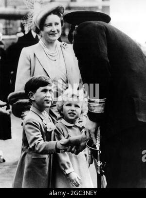 Prince Charles shakes hands with Rear-Admiral A G V Hubbeck , Admiral Superintendent of Portsmouth Dockyard , before the Royal children went aboard the royal yacht Britannia at Portsmouth . With the children is the Queen Mother who with Princess Margaret was seeing the children off on their voyage to meet the Queen and the Duke of Edinburgh at Tobruk . 15 April 1954 Stock Photo