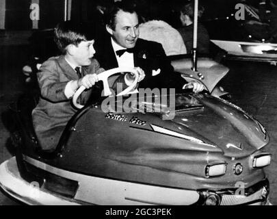 Prince Charles rides in a bumper car with David Monk. 18 December 1959 Stock Photo