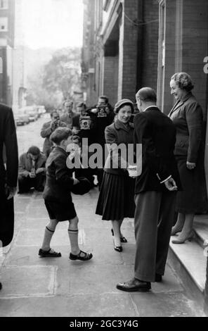 Prince Charles , cap in hand stands by whilst his Nanny , Miss Peebles , shakes hands with the headmaster of Hillside House School , Hans Palce , London , day school attended by Prince Charles . He was returning to school after the Easter Recess . 1 May 1957 Stock Photo