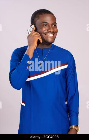 happy young black man smiling while making a phone call Stock Photo