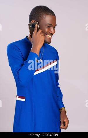 young african man smiling while making a phone call Stock Photo