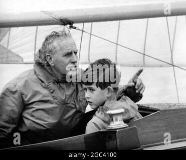 Uffa Fox and Prince Charles sailing - yacht racing at Cowes. In the Bluebottle 5 August 1957 Stock Photo