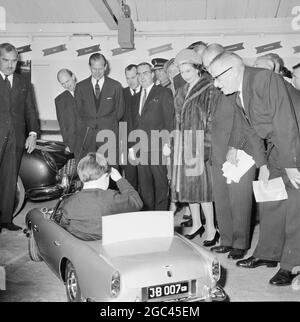 A gift for Prince Andrew: Newport, Pragnell , Buckinghamshire , England: Britain's Queen Elizabeth II and her consort Prince Philip The Duke of Edinburgh are pictured watching Ian Heggie, age 6, demonstrating a scale model of the famous James Bond car during their visit to North Buckinghamshire today. The demonstration took place at the Aston Martin Lagonda factory, which is presenting the model to Prince Andrew, the 6 year old third child of the Queen. The model is complete with electronic machine guns, which emit only, a realistic noise and are concealed in the sidelights, and a smoke screen Stock Photo