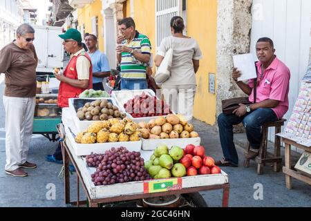 CARTAGENA DE INDIAS, COLOMBIA - AUG 28, 2015: Vendor with the fruit cart in the center of Cartagena. Stock Photo