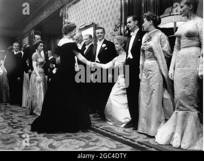 Her Majesty the Queen Elizabeth shakes hands with Brigitte Bardot during presentations to film stars before the Royal Command Film Performance of the film Battle of the River Plate 1956 Stock Photo