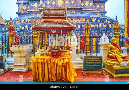 The shrines with Buddha Images around the main Chedi of Wat Phra That Lampang Luang Temple, Lampang, Thailand Stock Photo