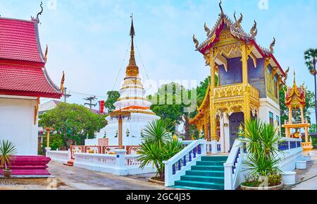 The Chedi (stupa), Ho Trai library and the Ho Rakang bell tower in background, Wat Sangkharam Temple, Lamphun, Thailand Stock Photo