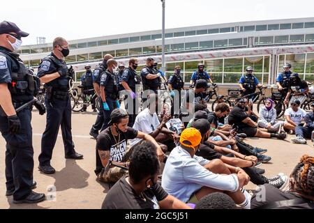 Washington DC, USA, 6 August 2021.  Pictured: Police line up behind demonstrators blocking traffic at Reagan National Airport during a Freedom Friday March.  Protesters aimed to block Senators from departing for recess because they had not yet acted to protect voting rights.  Approximately 25 demonstrators were arrested in this civil disobedience action.  Credit: Allison Bailey / Alamy Live News Stock Photo