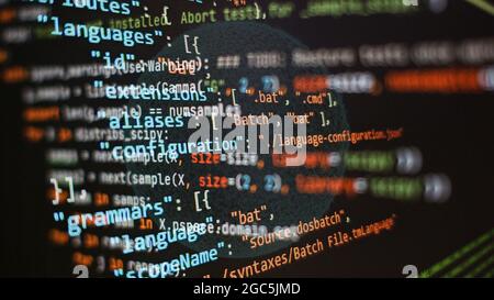 Website development. Developer working on program codes in office. Computer program. Programmer workplace. Programming code. Software source code. Stock Photo