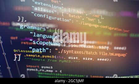 Website development. Developer working on program codes in office. Computer program. Programmer workplace. Programming code. Software source code. Stock Photo