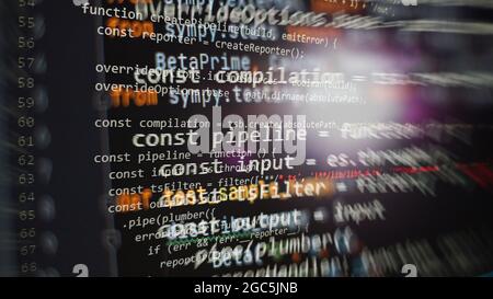Hacker background, Programmer working in desktop laptop, Blurred screen with selective focus, JS, Closeup cooperating in web specialist apps, Tech sou Stock Photo