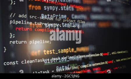 Hacker background, Programmer working in desktop laptop, Blurred screen with selective focus, JS, Closeup cooperating in web specialist apps, Tech sou Stock Photo