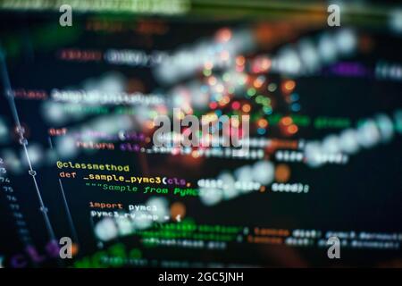 Hacker background, Programmer working in desktop laptop, Blurred screen with selective focus, JS, Closeup cooperating in web specialist apps, Tech sou Stock Photo