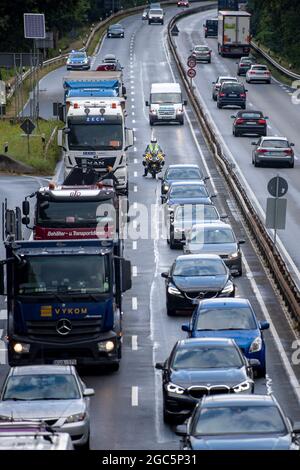 Bremen, Germany. 06th Aug, 2021. Roger Jahn, ADAC dust consultant, rides his motorcycle along the B75 between cars during a traffic jam. Holiday time can require a lot of waiting and patience as well as rest and relaxation. In view of the summer holidays, there are currently roadside cleanliness advisors on the roads on their motorcycles, advising and giving tips on how to get around the traffic jam as quickly as possible. Credit: Sina Schuldt/dpa/Alamy Live News Stock Photo