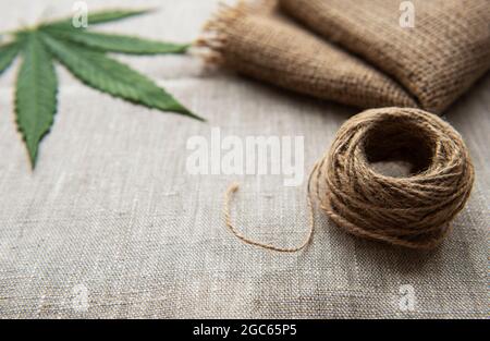 Cannabis leaves on the background of coarse hemp fabric Stock Photo