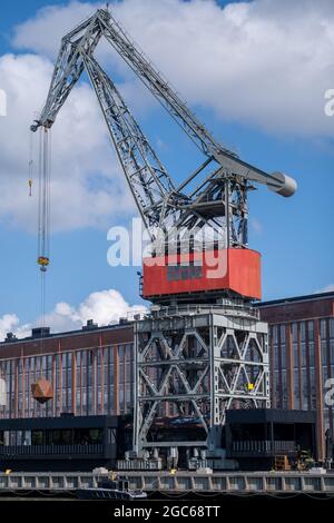 Turku / Finland - JULY 29, 2021: Closeup of an old decomissioned harbor crane against vivid sky. Stock Photo