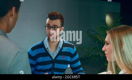 Group of diverse woman and men with tablet in modern office hall having work with documents and statistics Stock Photo