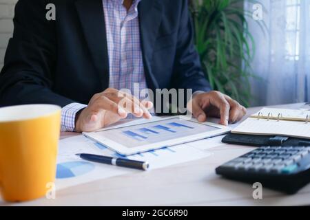 businessman working on digital tablet at office desk,  Stock Photo