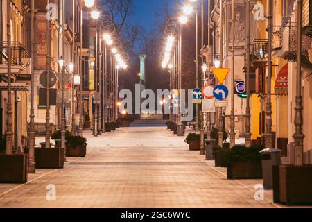 Poland, Holy Cross, Kielce, City street illuminated at night Stock Photo