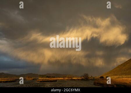 Usa, Idaho, Picabo, Storm clouds over landscape at sunset Stock Photo