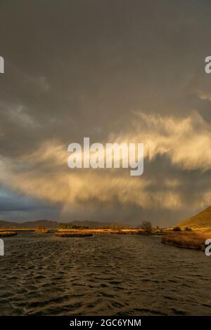 Usa, Idaho, Picabo, Storm clouds over landscape at sunset Stock Photo