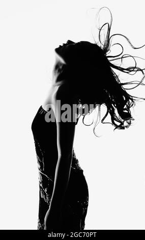 Profile of woman with long wavy hair Stock Photo