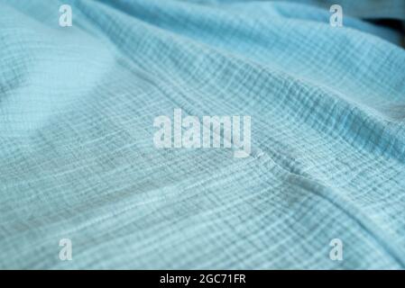Turquoise muslin fabric. Natural organic cotton textiles. Stock Photo