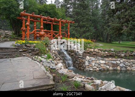 A bridge made from burled logs in Cascade public gardens in Banff, Alberta, Canada Stock Photo