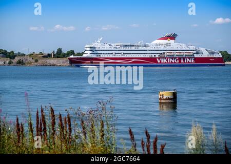 Helsinki / Finland - JULY 14, 2021: MV Viking XPRS, operated by Viking Line, passing Suomenlinna on its way to Tallinn. Stock Photo