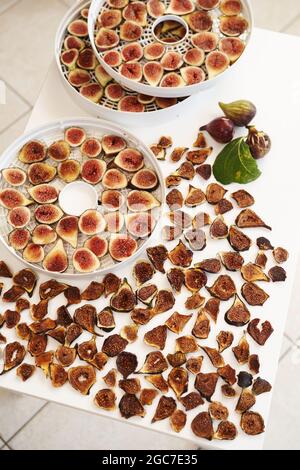 Dried figs on the table next to fresh figs on plates Stock Photo